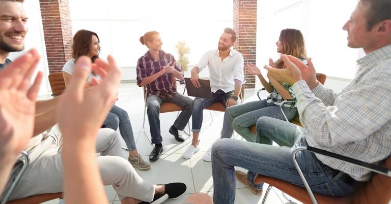 group meeting with people clapping