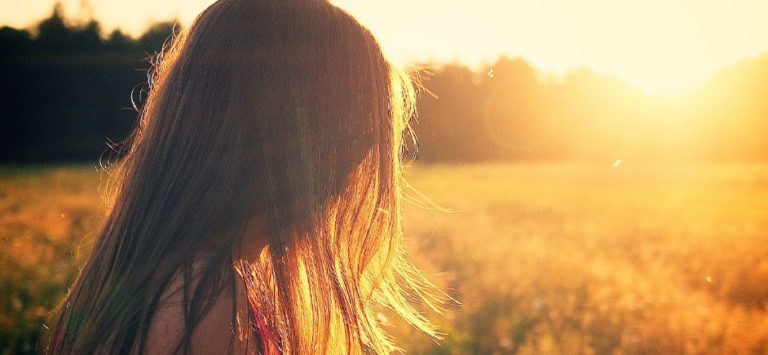 Woman in a field in the sunshine
