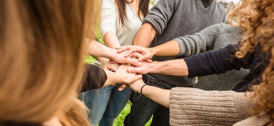 A group of people putting their hands together