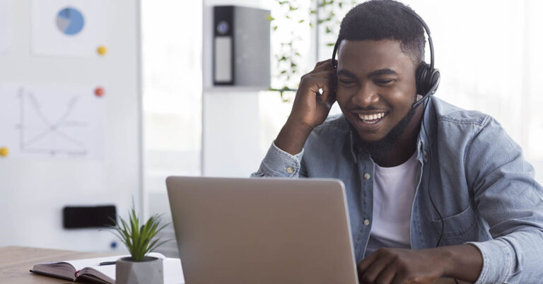 man in meeting on his computer