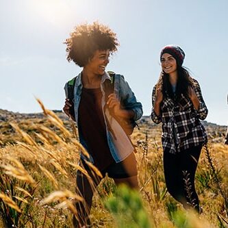 Photo of three young adults hiking in a group
